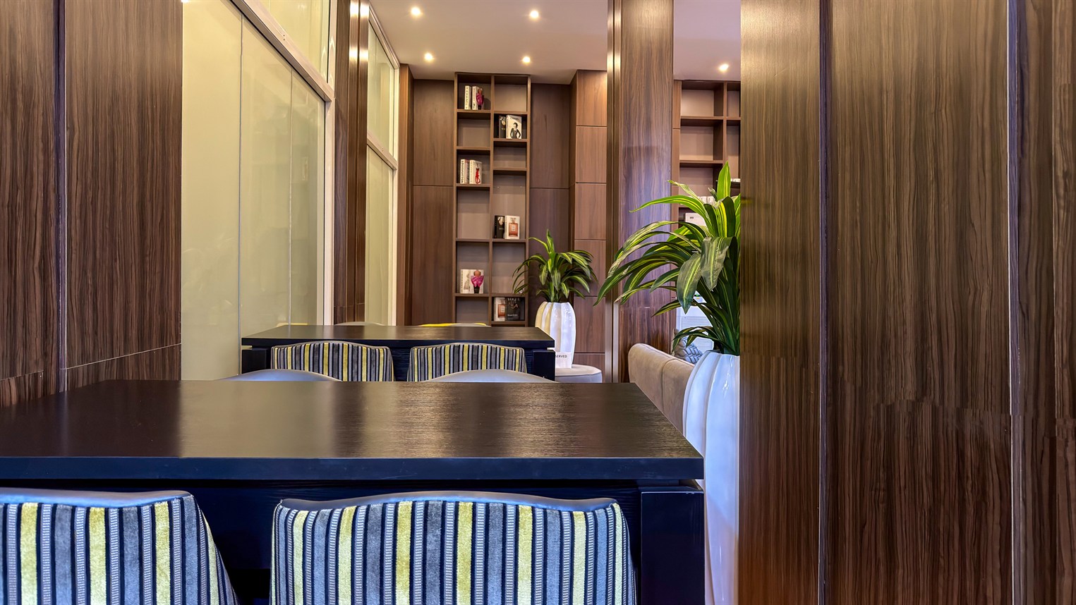 Timber panelling, shelving and a quiet table in a lounge
