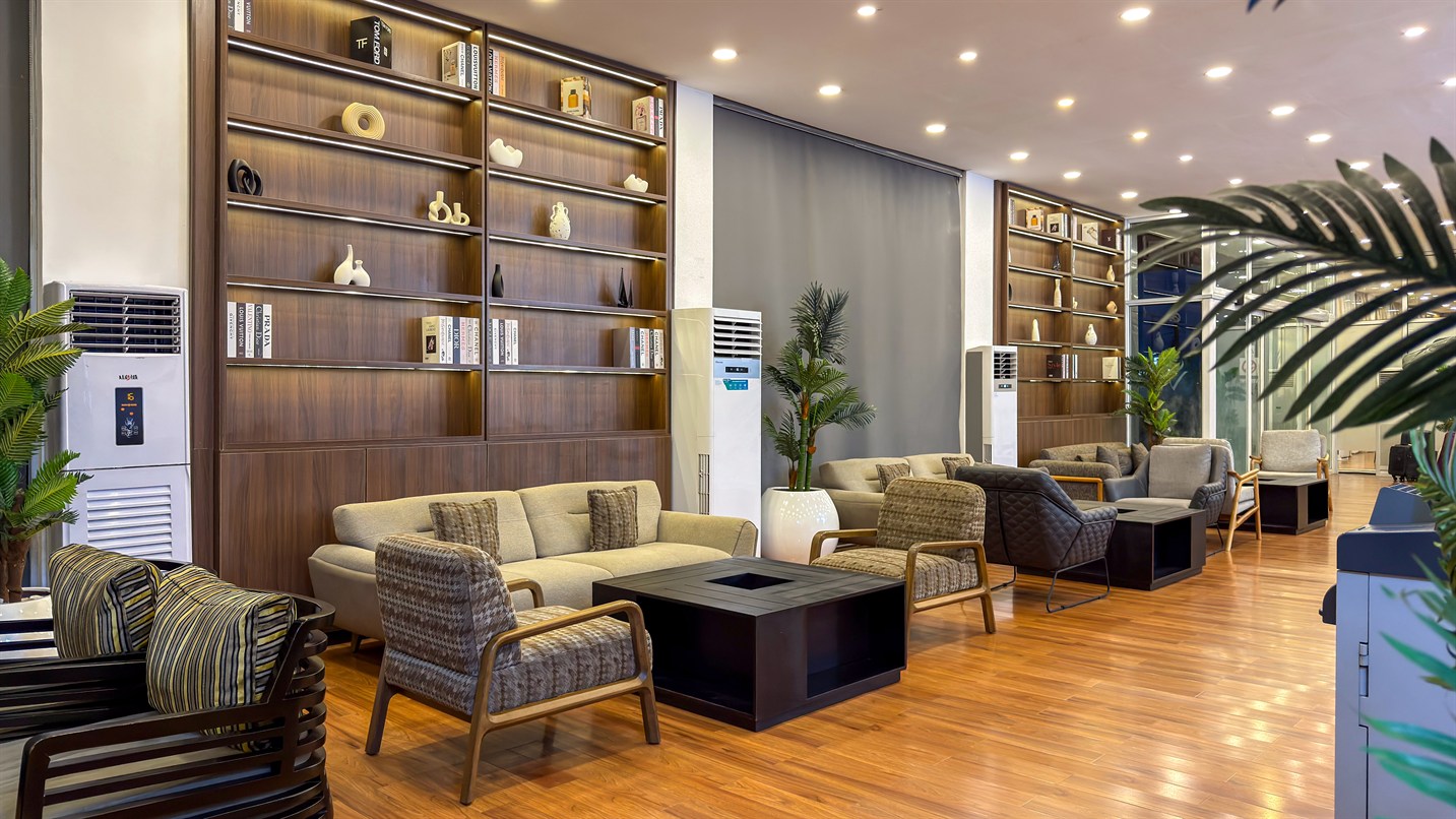 A quiet lounge with timber shelving and soft seating