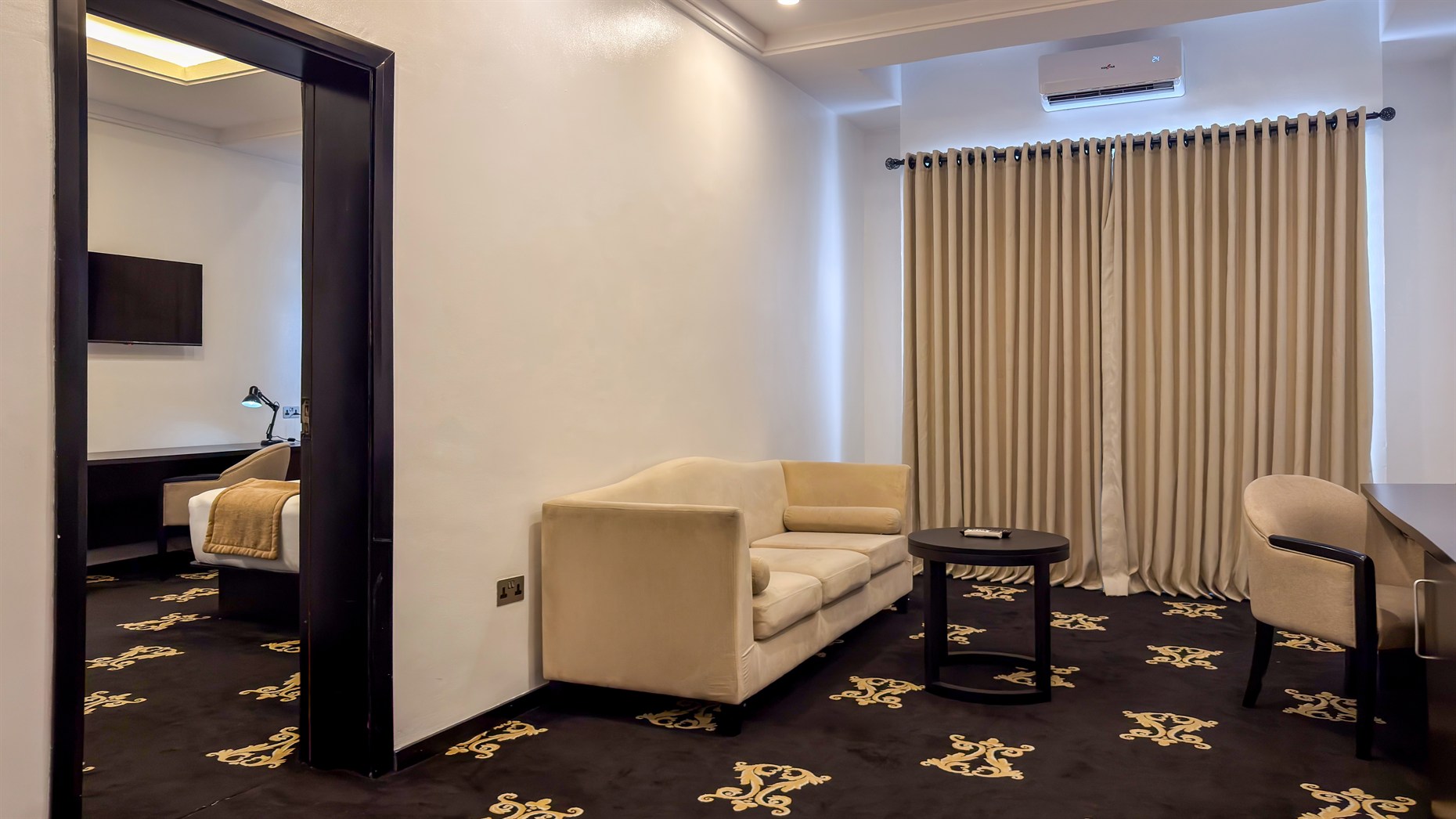 A suite living room opening onto the bedroom